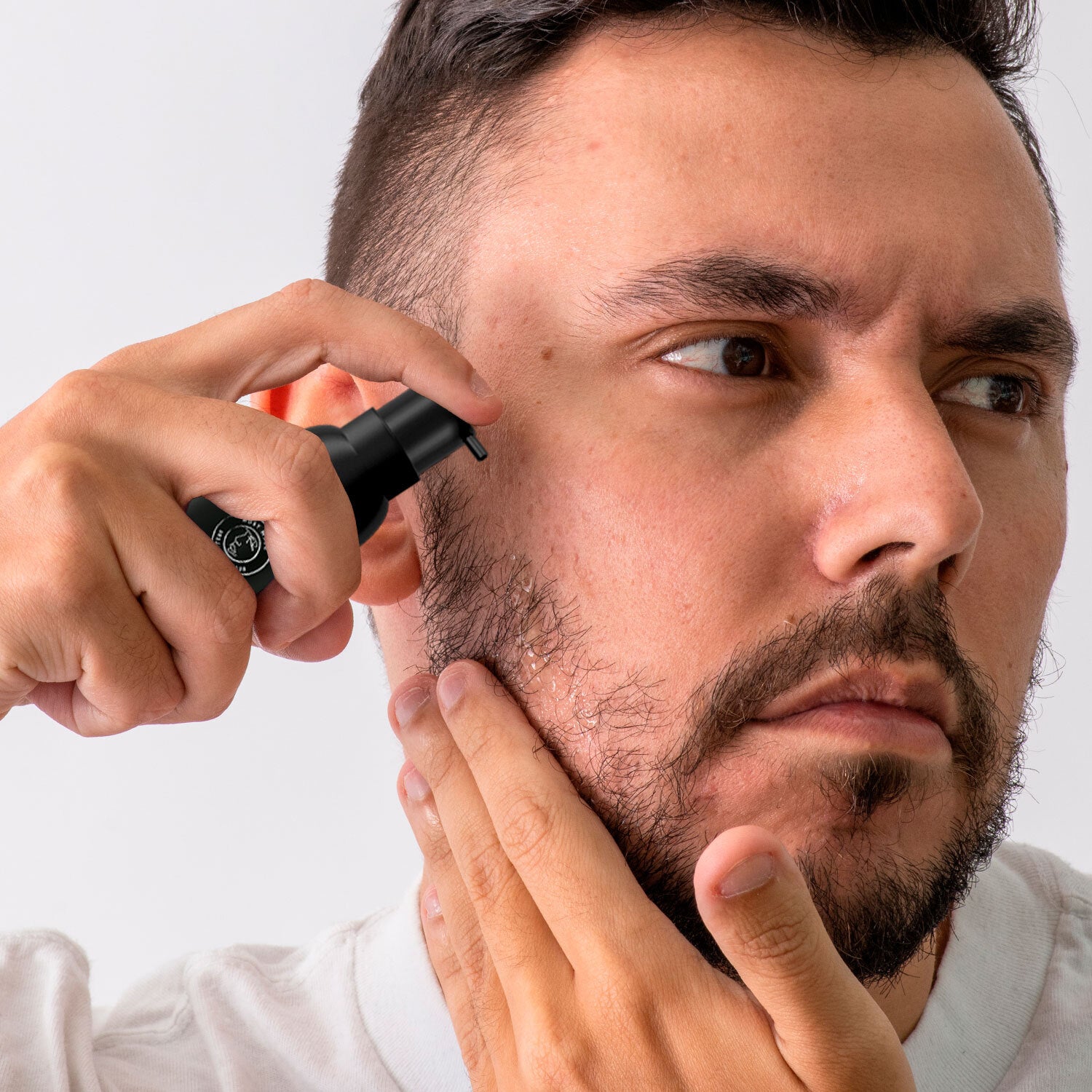 a man using beard growth serum