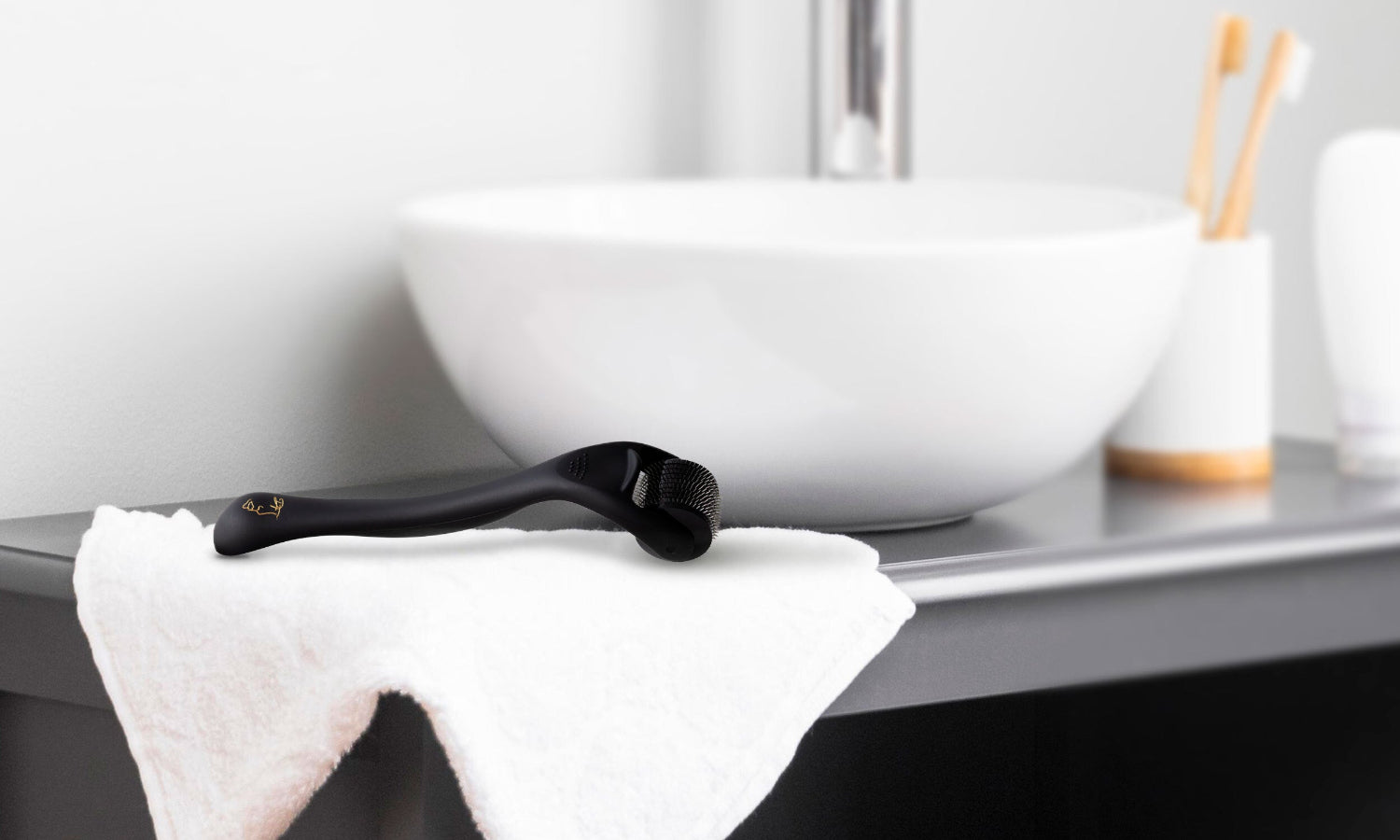 Lifestyle photo of a DermTech Derma Roller placed over a towel, showcasing the product in a practical setting for hair and beard growth care.