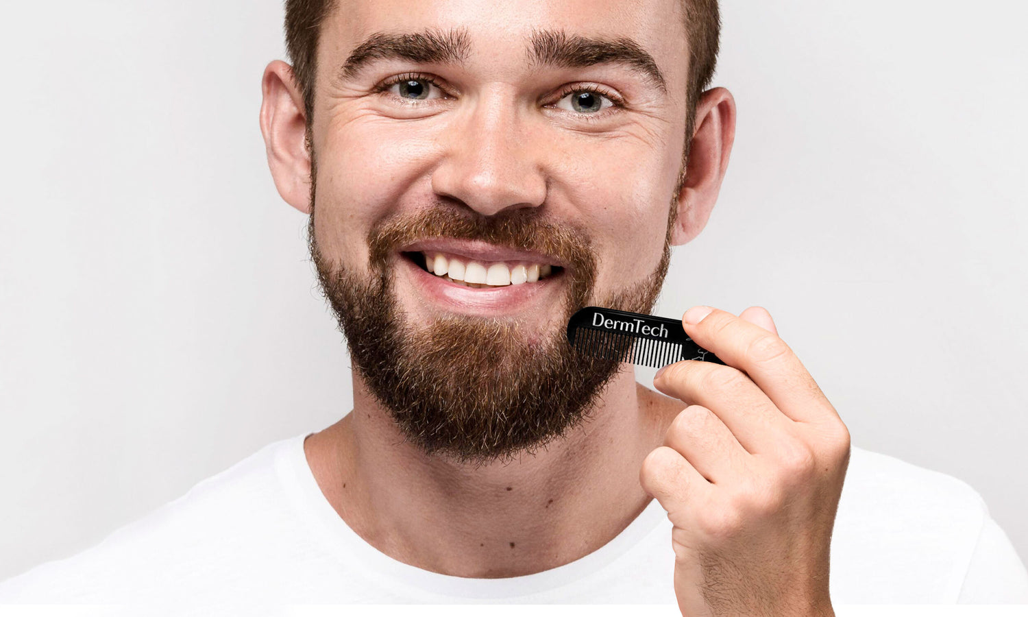 Image of a man using the DermTech Beard Comb from the DermTech kit, demonstrating effective beard grooming and styling for optimal beard care.