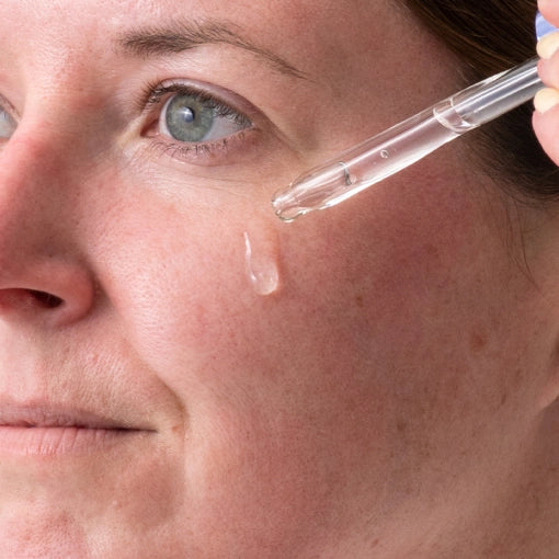 Woman applying hydrating serum or moisturizer to her face after using a derma roller to enhance absorption and skin rejuvenation. Discover the benefits of post-microneedling skincare routines with DermTechRoller.
